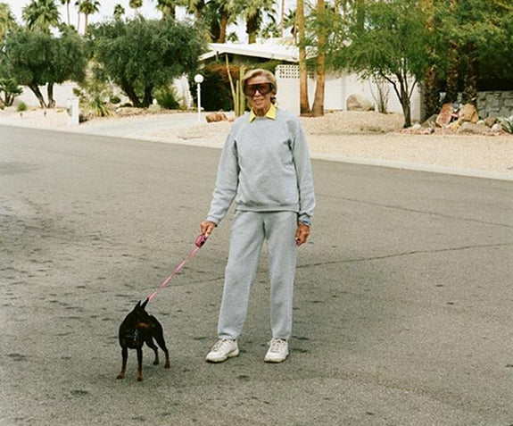 Older woman walking her dog with enthusiasm 